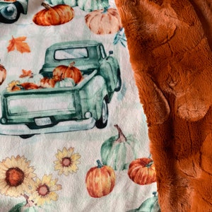 May include: A green vintage pickup truck filled with pumpkins and surrounded by sunflowers and pumpkins on a white background. The truck has a license plate that reads "T2356AH".