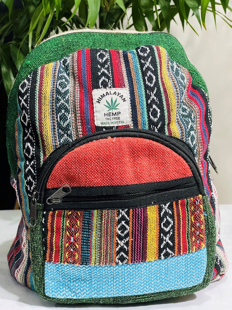 May include: A colorful striped hemp backpack with a red front pocket and a patch that says "Himalayan Hemp THC Free Made in Nepal".