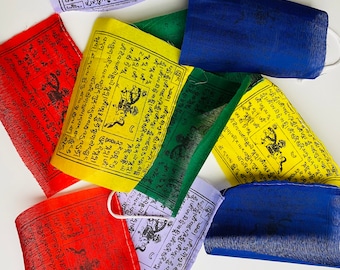 May include: A set of colorful prayer flags with Tibetan text and symbols. The flags are made of fabric and are strung together. The flags are a traditional Tibetan Buddhist symbol of peace and good luck.