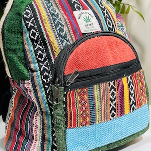 May include: A colorful hemp backpack with a patch that reads "Himalayan Hemp THC Free Made in Nepal". The backpack is made of a patchwork of different fabrics, including green, red, blue, yellow, and black.