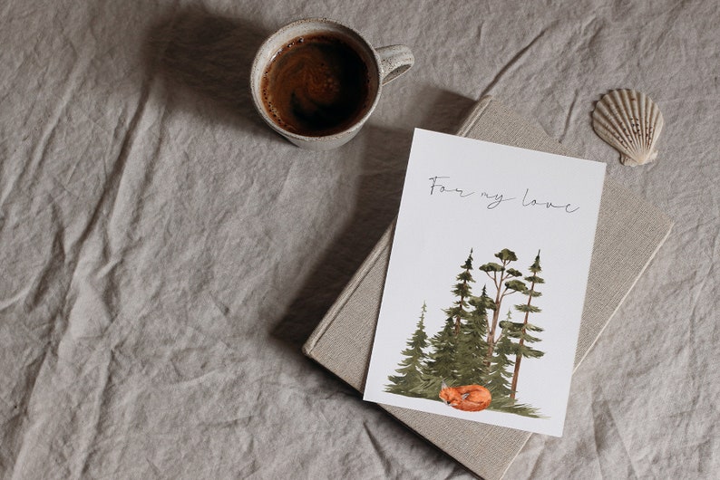 May include: A white card with the text "For my love" written in black ink. The card features a watercolor illustration of a sleeping fox in a forest setting with green trees.