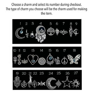 May include: A selection of 27 silver charms with various designs, including a crescent moon, a dreamcatcher, a tree of life, a skull, an owl, a butterfly, a heart, a lotus flower, a peace sign, a sun, a star, and a hand with an eye. The charms are numbered 1 through 27.