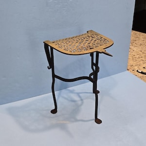 Antique iron and brass fireplace kettle trivet with penny feet