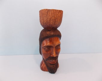 Vintage wood sculpture man with basket on head