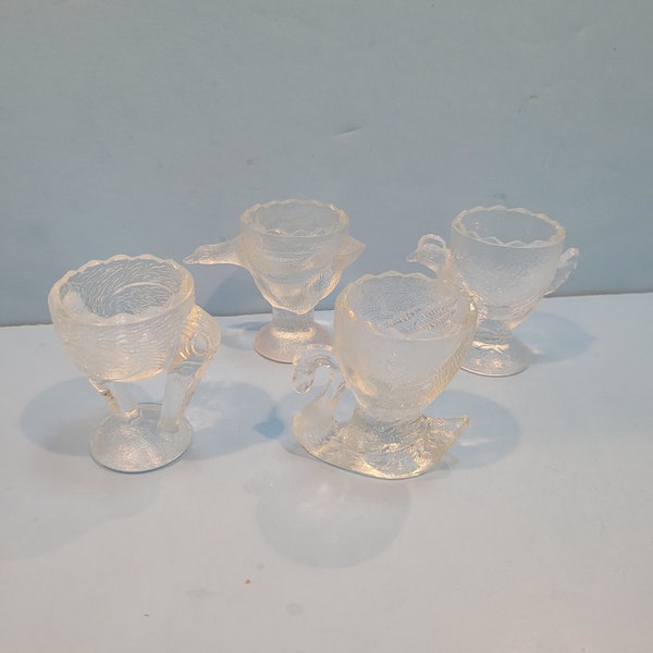 Pressed glass egg cups with various bird motifs