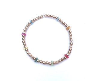 Gold metal beaded stretch bracelet with multicolor disc beads