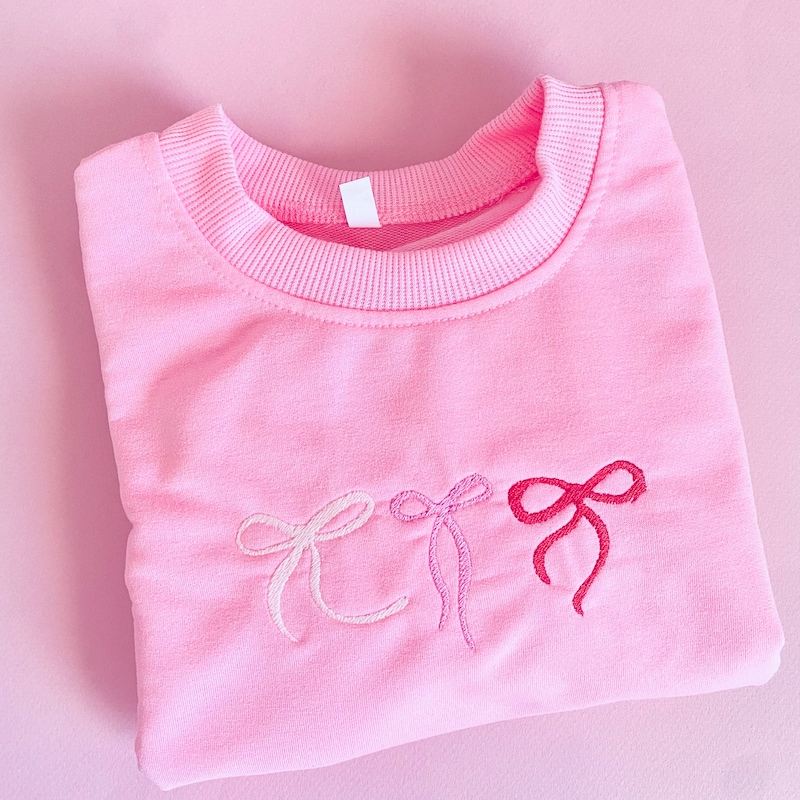 Pink sweater with pearl bows