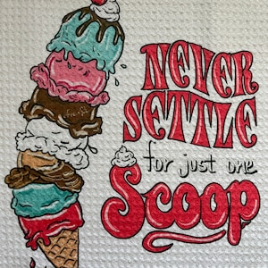 May include: A white kitchen towel with a colorful ice cream cone illustration and the text "NEVER SETTLE for just one Scoop". The ice cream cone has multiple scoops of different flavors, topped with a cherry.