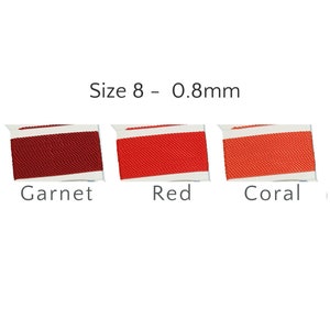 May include: Three spools of Size 8 - 0.8mm thread in Garnet, Red, and Coral. Each spool is a rectangular shape with a white label. The text "Size 8 - 0.8mm" is above the spools.