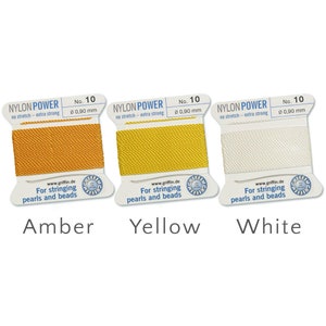 May include: Three spools of Nylon Power beading thread in amber, yellow, and white. Each spool is labelled with "No. 10" and "&Oslash; 0.90 mm" and the text "For stringing pearls and beads".