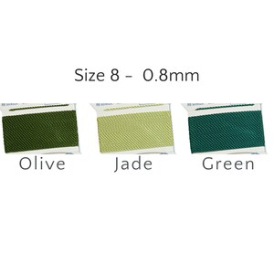May include: Three spools of Size 8 - 0.8mm cord in Olive, Jade, and Green. The spools are packaged in white and blue wrappers. The cord is tightly woven and appears to be made of a synthetic material.