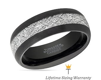 Op de afbeelding: Een zwarte ring van wolfraamcarbide met een zilveren inlay. De ring heeft een geborstelde afwerking en de woorden "Tungsten Carbide" zijn gegraveerd aan de binnenkant van de band.