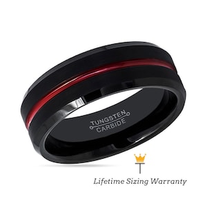 May include: Black tungsten carbide ring with a red stripe and the inscription "TUNGSTEN CARBIDE".
