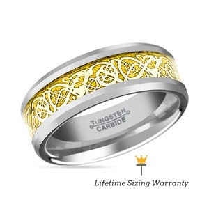 May include: A silver tungsten carbide ring with a yellow gold Celtic knot design. The ring is engraved with "TUNGSTEN CARBIDE".