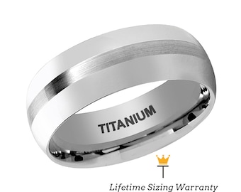 May include: A silver titanium wedding band with a brushed finish and a single, thin, polished silver stripe. The band is inscribed with the word "TITANIUM".
