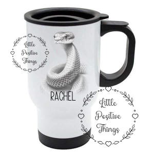 May include: White travel mug with a black lid and handle. The mug features a black and white illustration of a snake with the text "Little Positive Things" and "Rachel" printed on the mug.