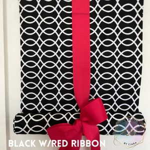 May include: Black and white patterned roller shade with a red ribbon tied in a bow. The shade is rolled up and the ribbon is tied around the roller. The text "BLACK W/RED RIBBON" is visible at the bottom of the image.