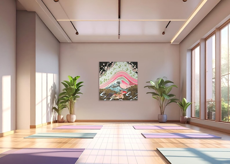Japanese inspired wave and blossom landscape paper collage art print featuring layered pink curves and textured patterns, displayed in a bright minimalist yoga studio with wooden floors and indoor plants.