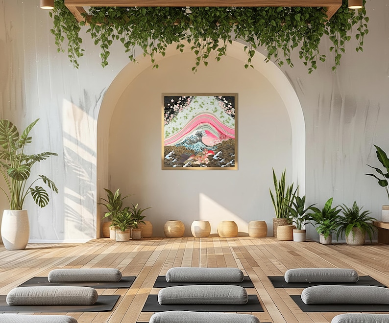Japanese inspired wave and blossom landscape paper collage art print in a gold frame displayed in a tranquil yoga studio with wooden floors, meditation cushions, and lush greenery.