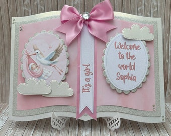 Personalised New Baby girl arrival storybook card. With gift box.  Stork carrying baby. Welcome to the world. Daughter Granddaughter Niece.