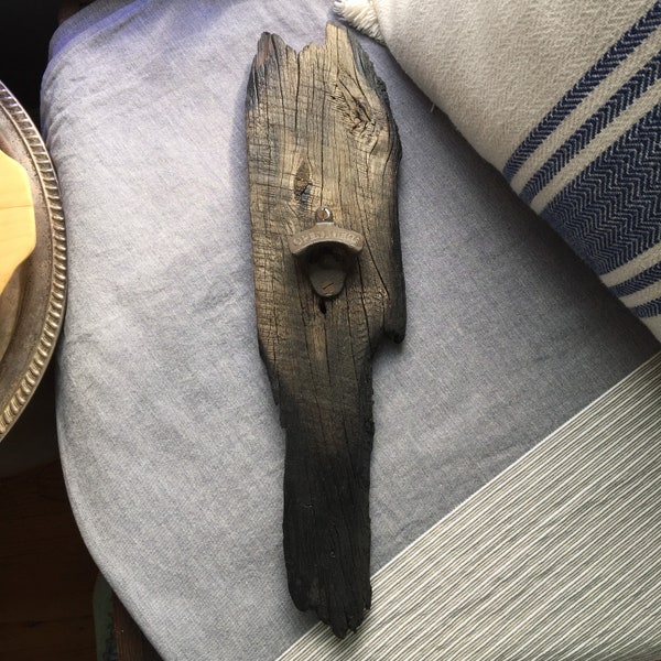 Burned in a barn fire wood reclaimed and made into a bottle opener