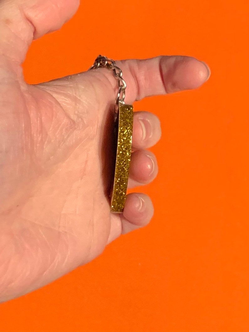Gold Go Away keychain