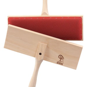 May include: Two wooden hand carders for fiber preparation. Each carder has a light wood handle and a rectangular pad with red bristles. The Ashford New Zealand logo is visible on one carder.