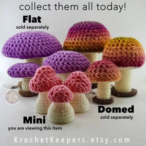 May include: A selection of crocheted mushroom ornaments in different sizes and colours, including purple, pink, and orange. The mushrooms have white stems and brown bases. The image includes the text "collect them all today!" and "KrochetKeepers.etsy.com".
