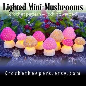 May include: A group of crocheted mushroom lights with glowing pink and beige caps. The mushrooms have white stems and are displayed on a dark surface. The image includes the text "Lighted Mini-Mushrooms" and "KrochetKeepers.etsy.com".
