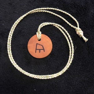 Viking necklace made from solid, oiled Boxwood with the runes for decisive action, victory and achievement in arms, burned into the grain.