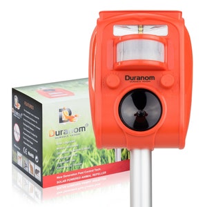 May include: Orange solar powered animal repellent with a motion sensor, speaker, and flashing light. The device is labeled "Duranom Durable Venom" and features the text "New Generation Pest Control Tech. Solar Powered Animal Repeller".
