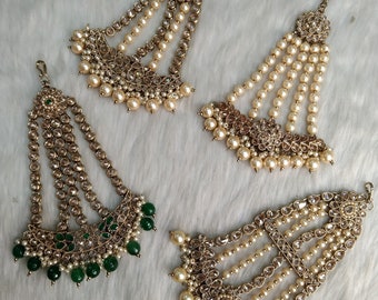 May include: Four gold-toned hair accessories with pearl and crystal embellishments. Two of the accessories have white pearls, and one has green beads.