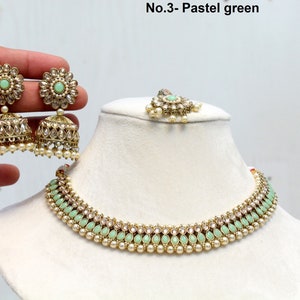 May include: A gold necklace with a pastel green stone design and pearl accents. The necklace is paired with matching earrings with a similar design. The text "No.3 - Pastel green" is visible in the image.