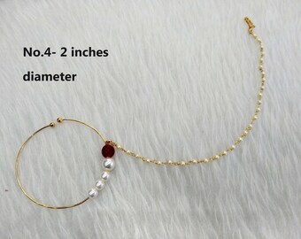 May include: Gold nose ring with a 2-inch diameter, featuring a chain with white pearls and a red bead. No.4 - 2 inches diameter.