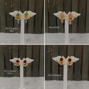 May include: Four pairs of drop earrings displayed on white stands. No. 9 features seagreen mint stones, No. 10 pink stones, No. 11 maroon and green stones, and No. 12 maroon stones. Each earring has a square or oval top, small pearls, and a dangling bead.