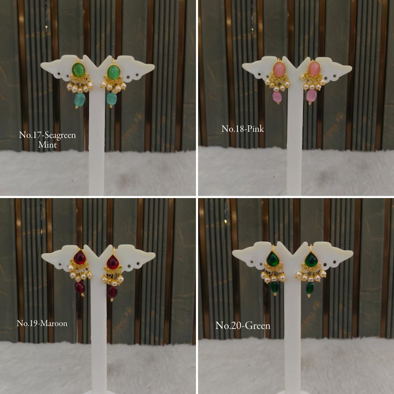 May include: Four pairs of gold-tone drop earrings displayed on white stands. Each pair features a central oval stone, small gold accents, and dangling beads. The sets are labeled No.17-Seagreen Mint, No.18-Pink, No.19-Maroon, and No.20-Green.