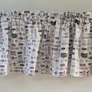 May include: White valance featuring a repeating pattern of patriotic symbols, including flags, maps, and words such as "Honour" and "Courage." The valance is gathered at the top and has a rod pocket. The fabric is a cotton blend.