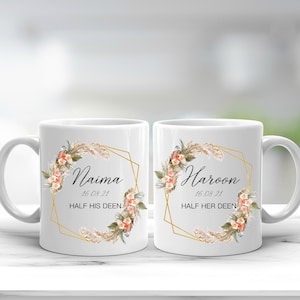 May include: Two white ceramic mugs with gold geometric frames and floral designs. The mugs are personalised with the names "Naima" and "Haroon" and the date "16 08 21". The text "Half His Deen" and "Half Her Deen" are also included on the mugs.