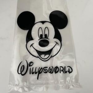 May include: Clear plastic bag featuring a black and white Mickey Mouse graphic and the text "WillysWorld" in a script font. The bag is sealed at the bottom and appears to be empty.