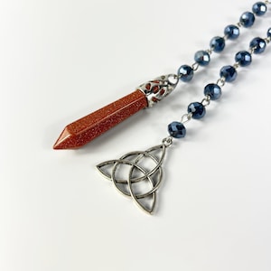 Goldstone dowsing pendulum, triquetra, rosary witch ladder, divination