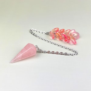 Rose quartz dowsing pendulum, sakura petals, divination tool for witchcraft and energy work