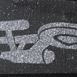 May include: A silver glitter iron-on patch featuring the iconic Star Trek Starship Enterprise and a star. The patch is perfect for adding a touch of sci-fi fandom to clothing, bags, or other fabric items.