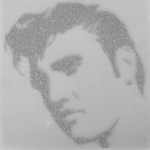 May include: A black and white portrait of a man with a short, slicked-back hairstyle. The image is made of small, sparkly silver glitter.