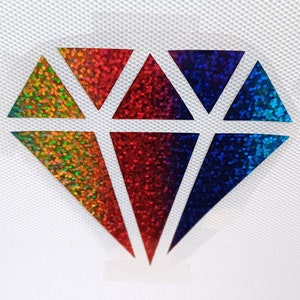 May include: A rainbow glitter diamond shape with a white outline.