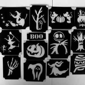 May include: Set of 12 Halloween stencils, featuring various spooky designs, including a witch, a pumpkin, a ghost, a tree, a skeleton, and a mummy. The stencils are black and white and are perfect for creating Halloween crafts.