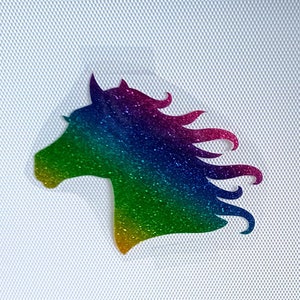 May include: A rainbow glitter horse head silhouette. The horse's mane is flowing in the wind.