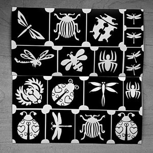 May include: A sheet of black and white stencils with various insect and animal designs. The designs include a ladybug, a butterfly, a spider, a bee, and a beetle.