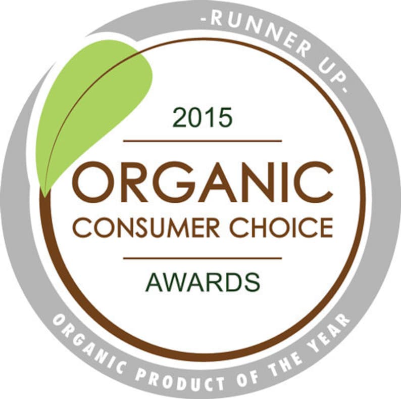 May include: A brown and gray circle with a green leaf and the text "2015 Organic Consumer Choice Awards - Runner Up - Organic Product of the Year"