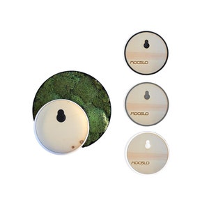 May include: Three round wooden wall decor pieces with a black, gray, and white frame. Each piece has a hole for hanging and the word "MOOSLO" printed on the front.