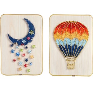 Könnte beinhalten: Zwei Holzrahmen mit String Art. Das erste Stück zeigt einen blauen Halbmond mit bunten Sternen, die von ihm fallen. Das zweite Stück zeigt einen Heißluftballon mit roten, orangen, gelben und blauen Streifen.